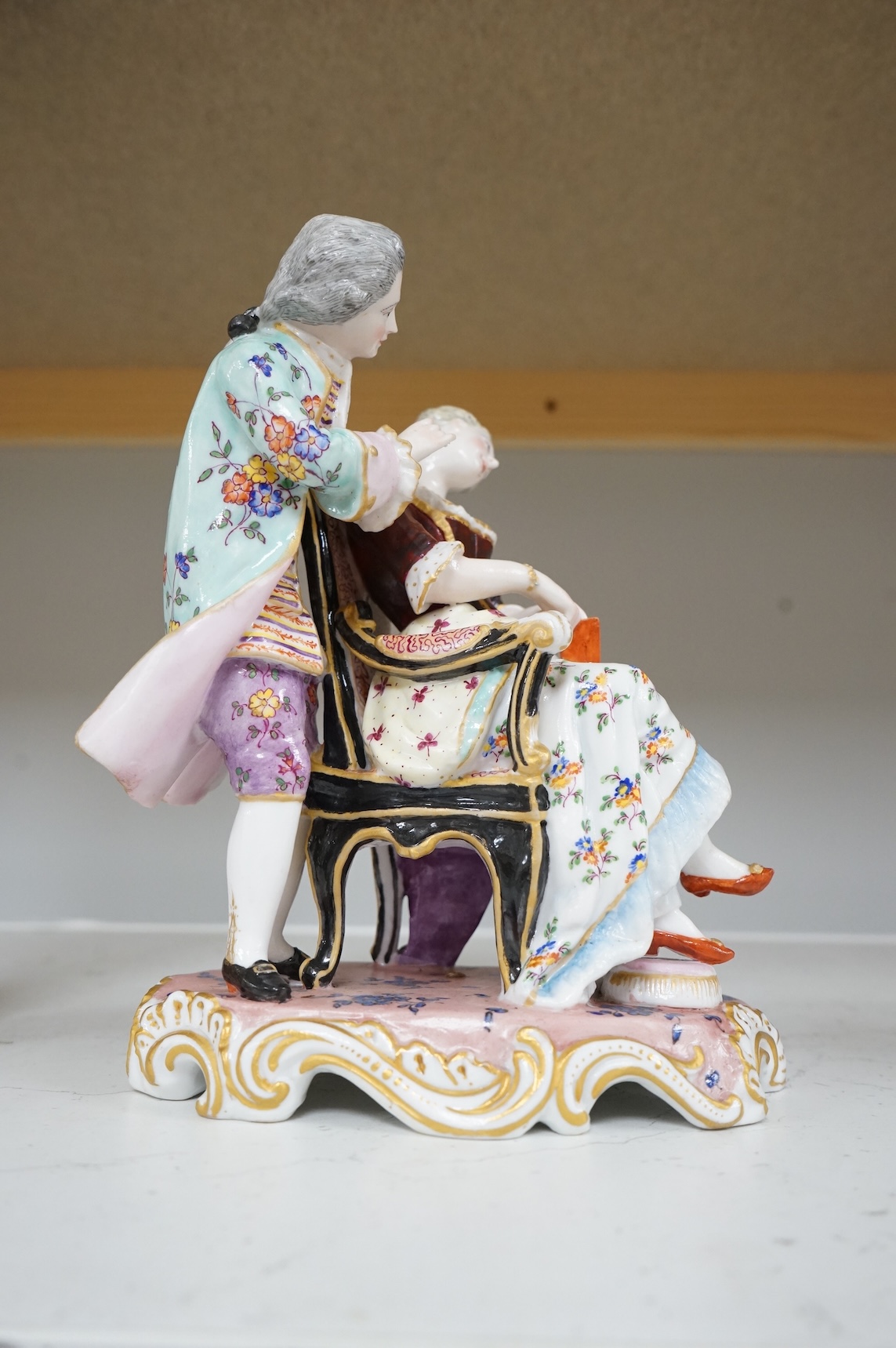 A German porcelain group of a seated sleeping beauty, 21cm high